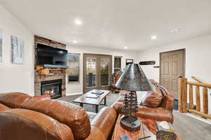 Carpeted living room with a fireplace