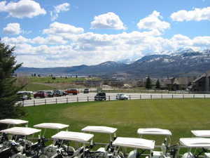 Surrounding community featuring a lawn and a mountain view