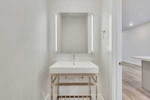 Bathroom featuring hardwood / wood-style flooring and sink