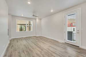 Unfurnished room featuring ceiling fan and light hardwood / wood-style flooring