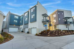 View of property exterior with a balcony and a garage