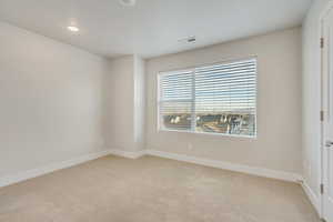 Unfurnished room with light colored carpet