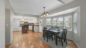 Dining space with light hardwood / wood-style flooring