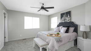 Carpeted bedroom featuring ceiling fan