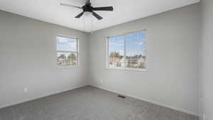 Unfurnished room with ceiling fan and carpet floors