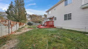 View of yard featuring a deck with mountain view