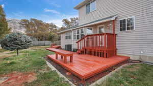 Wooden terrace with a yard and central AC unit