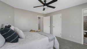 Bedroom featuring carpet floors, ensuite bath, and ceiling fan