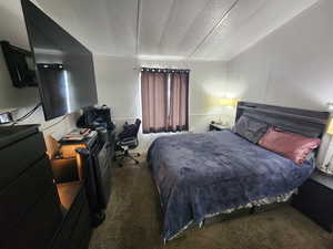 Carpeted bedroom with a textured ceiling