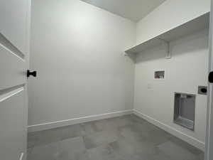 Laundry area featuring hookup for an electric dryer, hookup for a washing machine, and heating unit