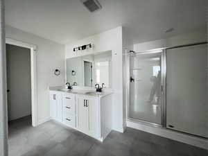 Bathroom with a shower with door and vanity