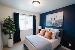 Bedroom featuring light colored carpet