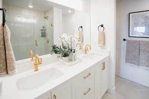 Bathroom with hardwood / wood-style floors, vanity, and a shower with shower door