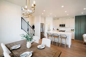 Dining room featuring hardwood / wood-style floors and an inviting chandelier