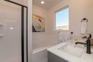 Bathroom with tiled bath and vanity