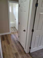 Corridor with light hardwood / wood-style flooring