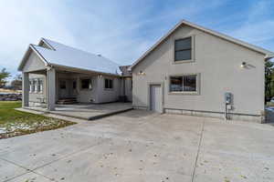 covered patio with entrances to house and garage