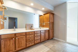 master bathroom with double sinks, toilet room and walk in shower