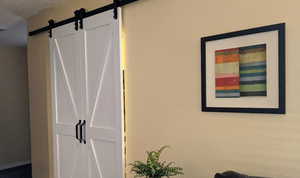 Interior space featuring a barn door and a textured ceiling