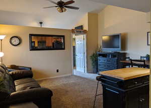 Living room with carpet, vaulted ceiling, and ceiling fan