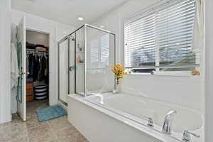 Bathroom with tile patterned floors and separate shower and tub