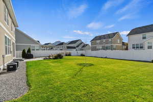 View of fully fenced yard with central air condition unit and a patio