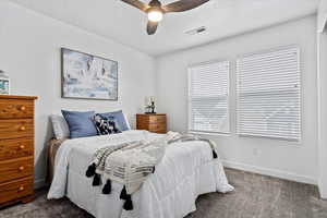 Carpeted bedroom with ceiling fan