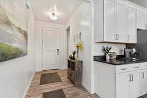 Doorway to outside with light wood-type flooring