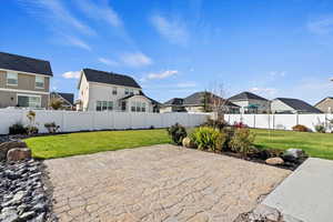 View of patio and fully fenced yard