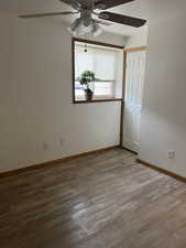 Unfurnished room with ceiling fan and light wood-type flooring