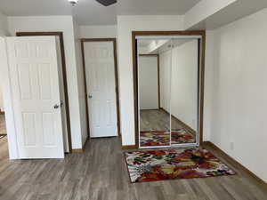 Bedroom featuring a closet, hardwood / wood-style flooring, and ceiling fan