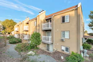 View of building exterior with a wall mounted AC