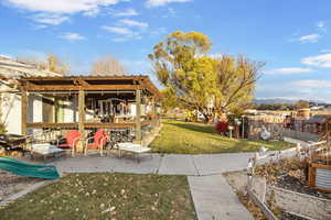 View of yard featuring a patio area and outdoor kitchen