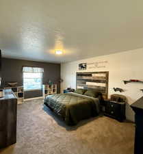 Bedroom with carpet floors and a textured ceiling