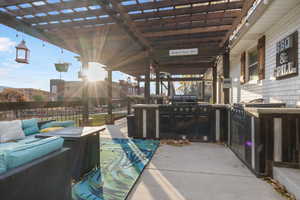 View of outdoor kitchen patio / terrace featuring an outdoor living space, a pergola, and area for grilling