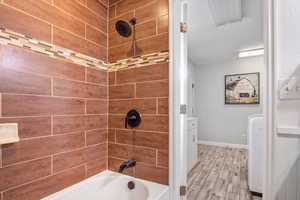 Bathroom featuring Tile wood-style floors and tiled shower / bath