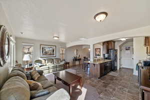 Living room with sink and a textured ceiling