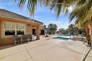 View of swimming pool with an in ground hot tub and a patio