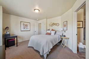 Bedroom with carpet flooring and a textured ceiling