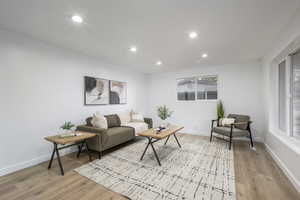 Living room featuring LVP flooring and a wealth of natural light