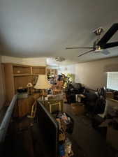 Interior space featuring ceiling fan and carpet floors