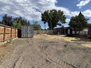 View of yard with a storage unit