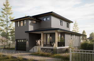 View of front of property with covered porch and a garage