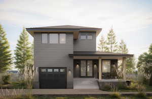 View of front of house featuring covered porch and a garage