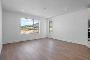 Spare room with hardwood / wood-style floors and a textured ceiling