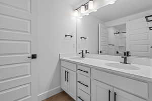 Bathroom with a shower, wood-type flooring, and vanity