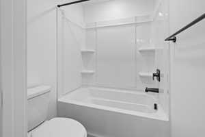 Bathroom featuring  shower combination and toilet