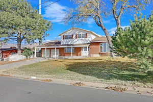 Front facade with a front yard and a garage