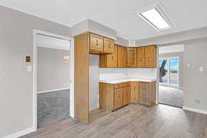 Kitchen with an inviting chandelier and light hardwood / wood-style flooring