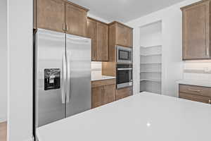 Kitchen featuring appliances with stainless steel finishes and tasteful backsplash